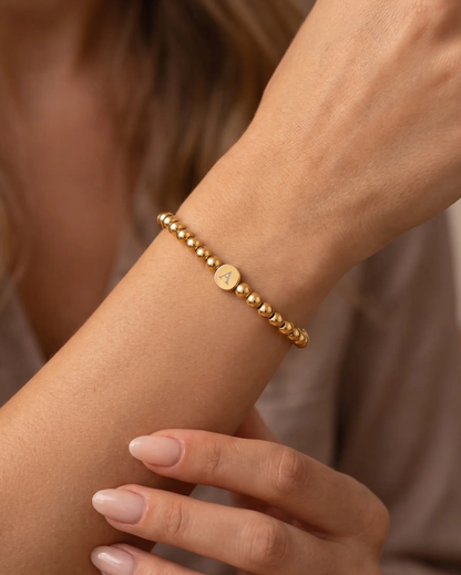 studio-ai bracelet-engraved-initial-bead-bracelet_lifestyle1_a1+solo.png