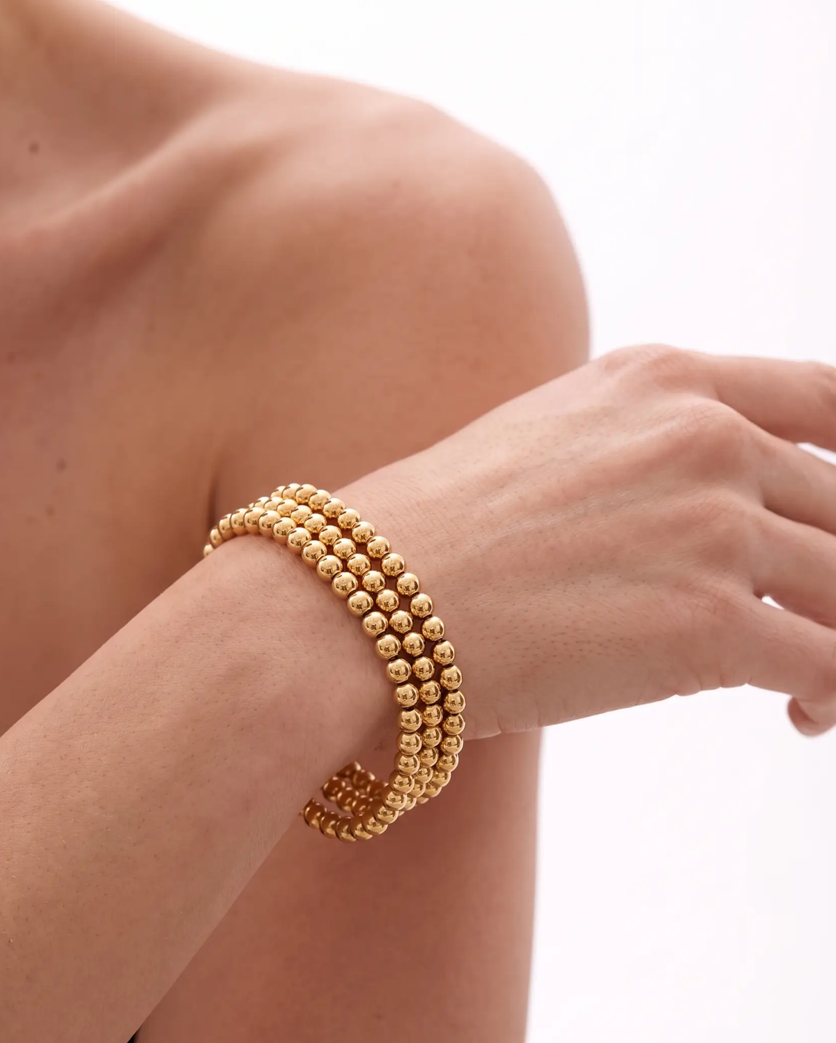 studio-ai bracelet-trio-gold-bead-bracelet-stack_lifestyle1_a1+solo.png