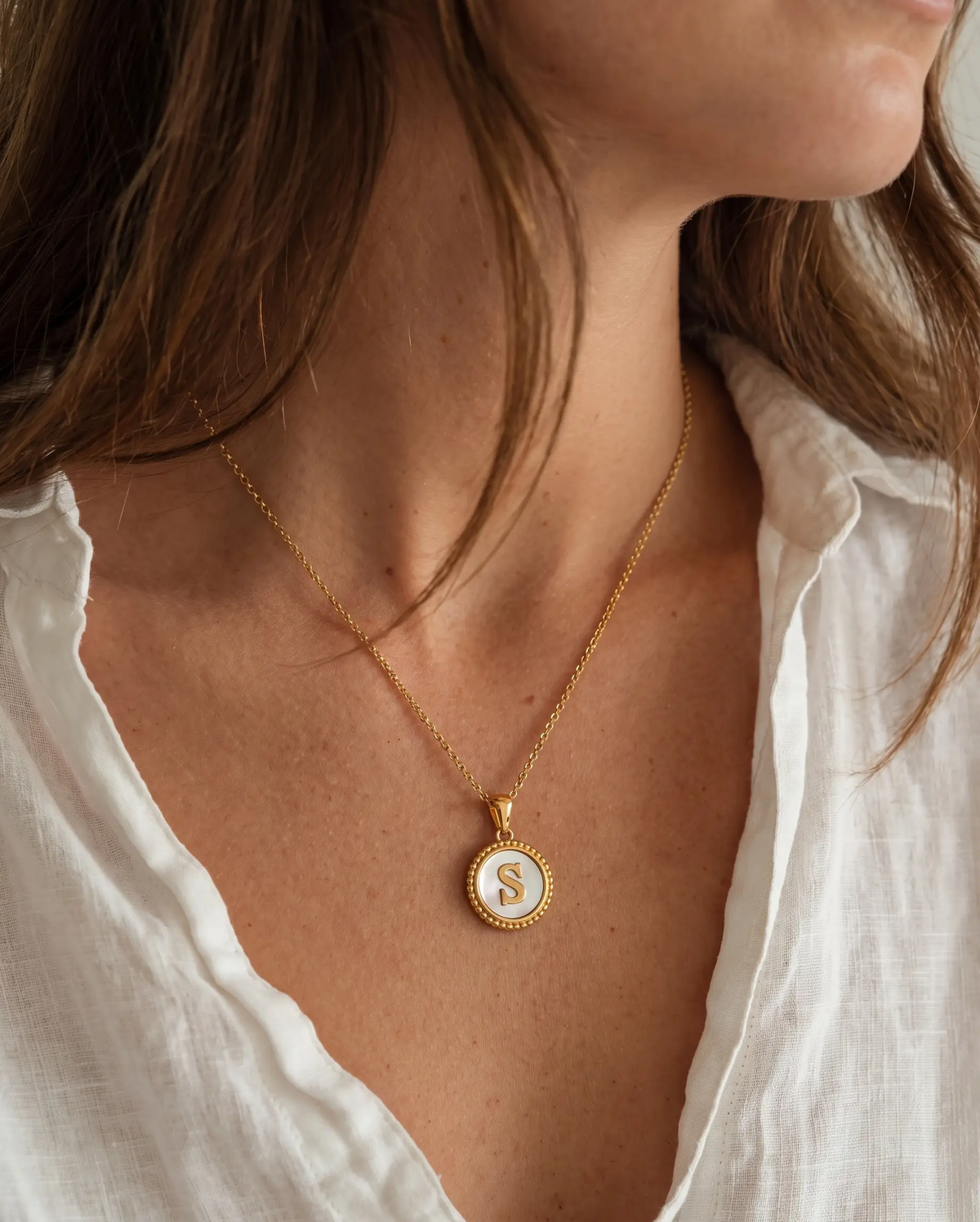 studio-ai necklace-nacre-initial-pendant-necklace_lifestyle1_a1+solo.png